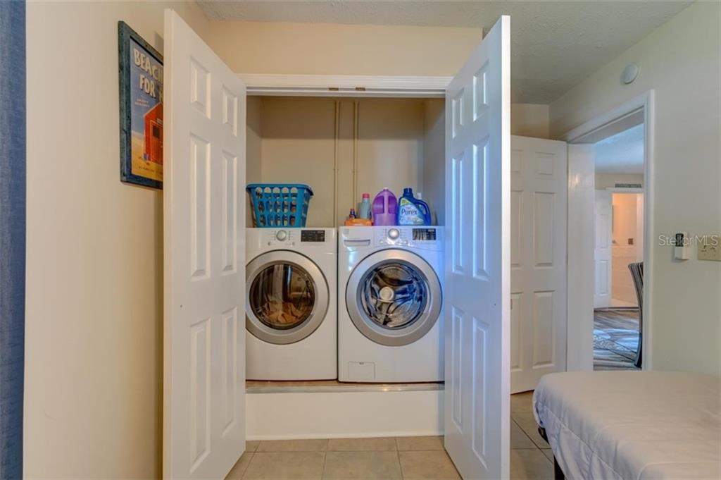 White washer and dryer in closet.