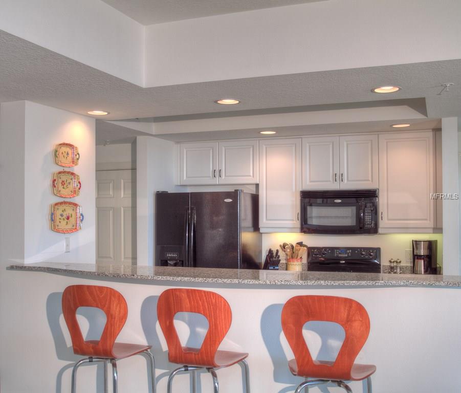 Kitchen island with three red chairs.