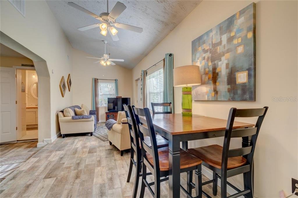 Dining room with wooden table and chairs.