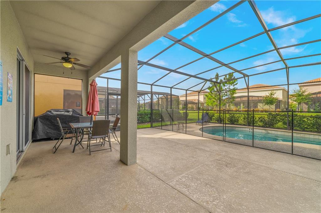 Covered patio with pool and patio furniture.