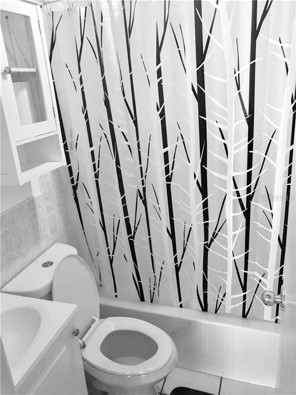 Black and white tree shower curtain bathroom.