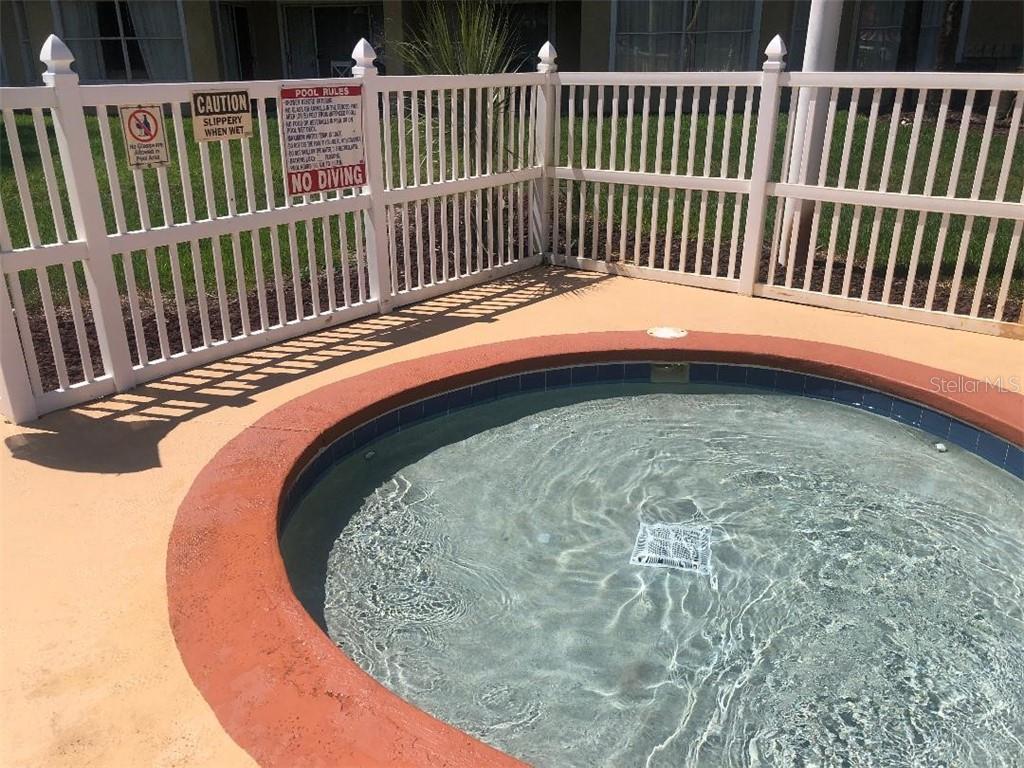 A round hot tub with blue water.