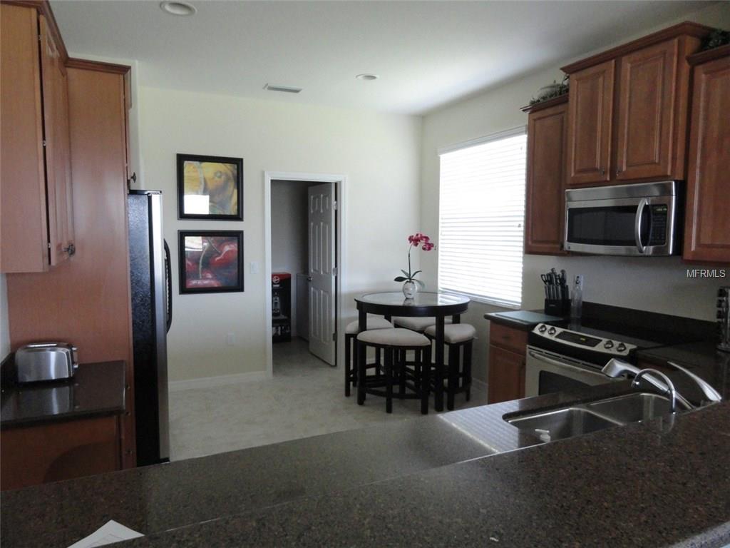 Kitchen with black countertops and island.