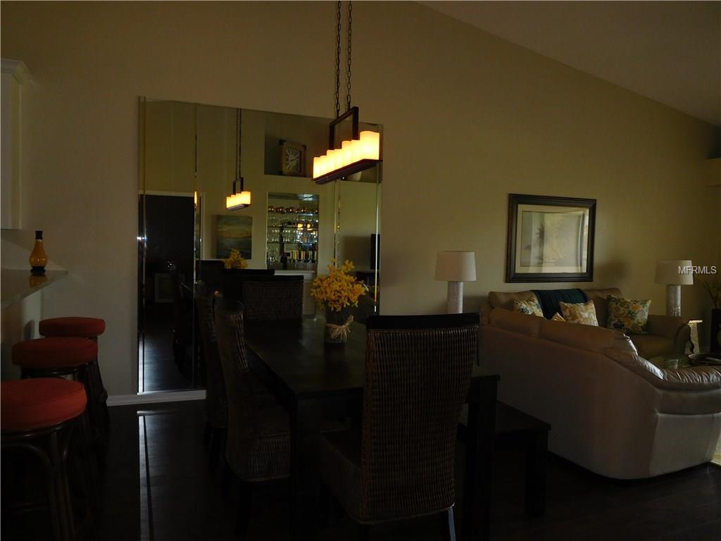 Dining room with chandelier and couch.