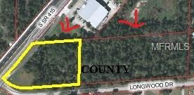 Aerial view of a wooded lot for sale.