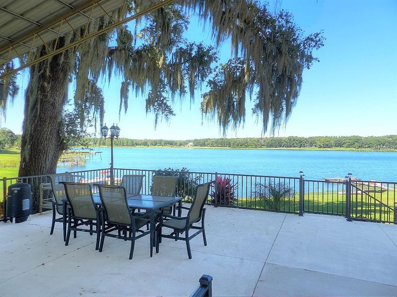 Lakefront patio with a table and chairs.