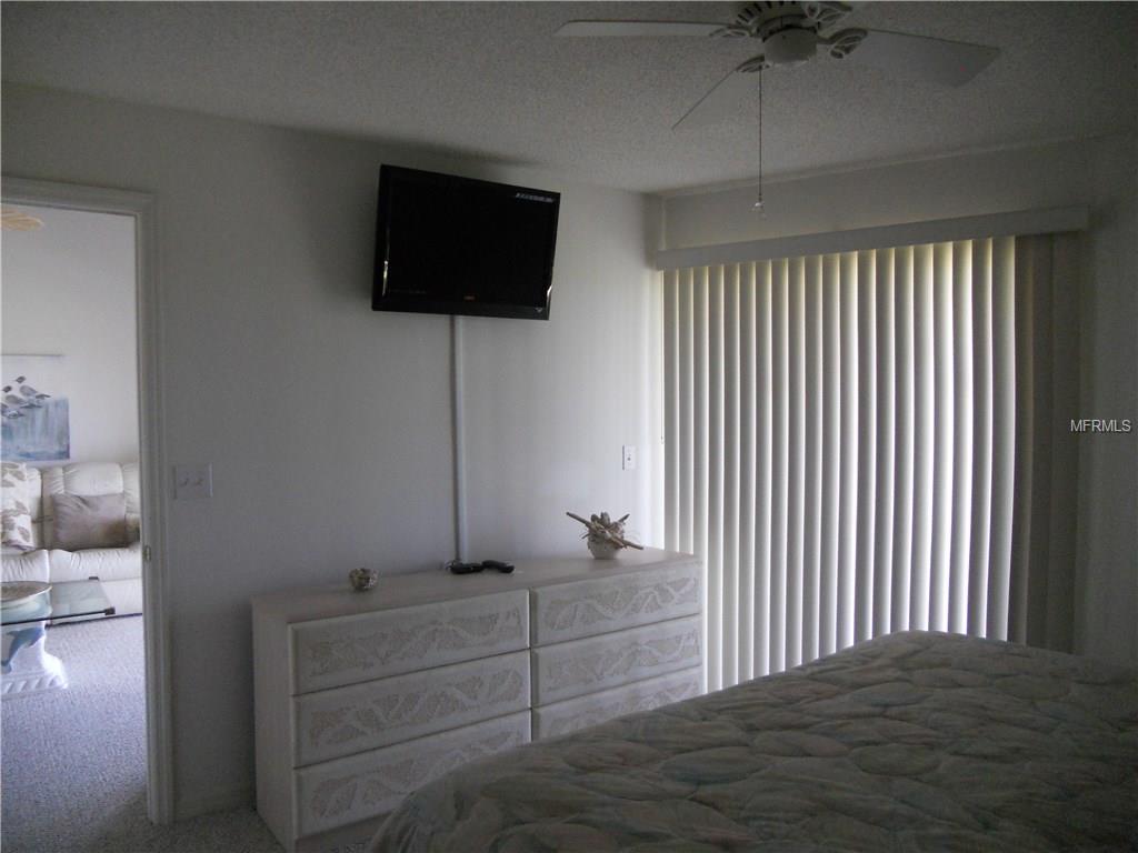 Bedroom with a TV and white dresser.