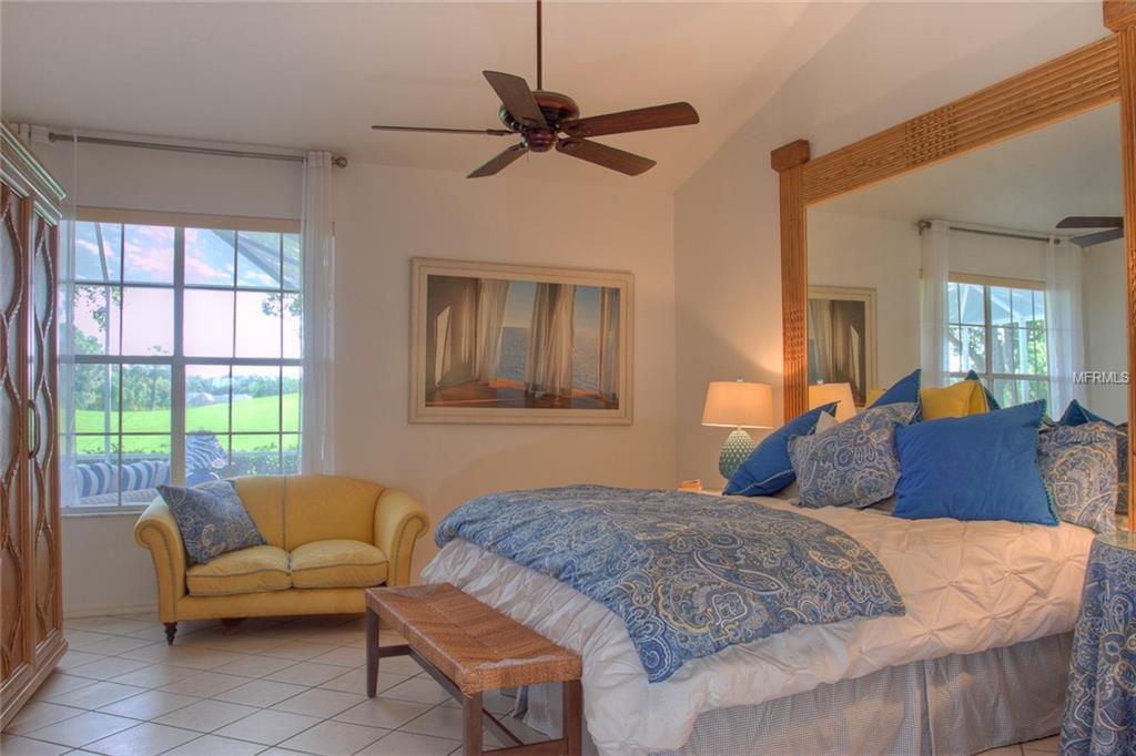 Bedroom with a king-size bed and yellow couch.