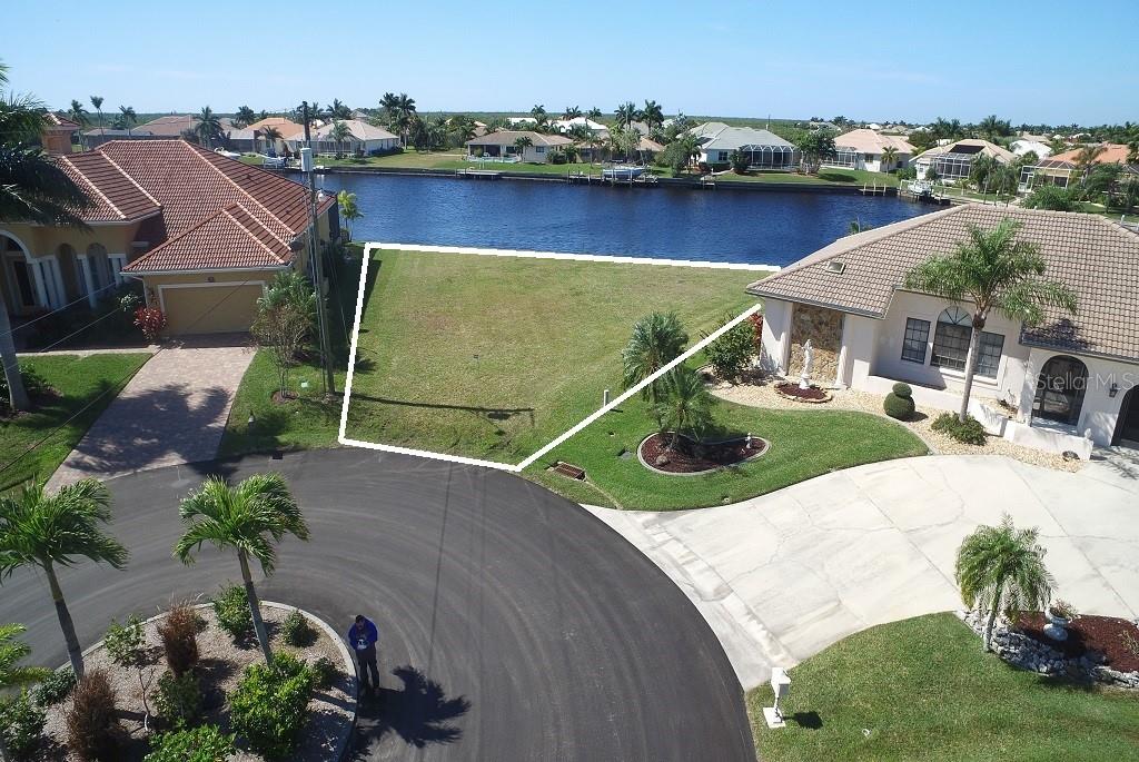 Aerial view of a vacant lot by the water.