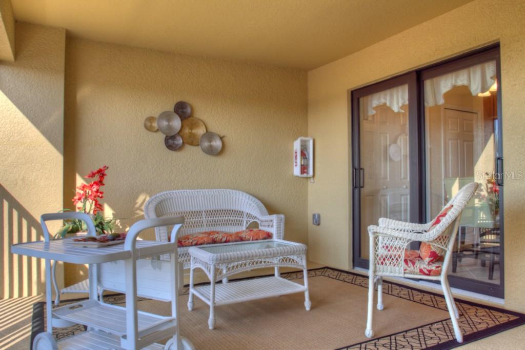 White patio furniture with sliding glass doors.