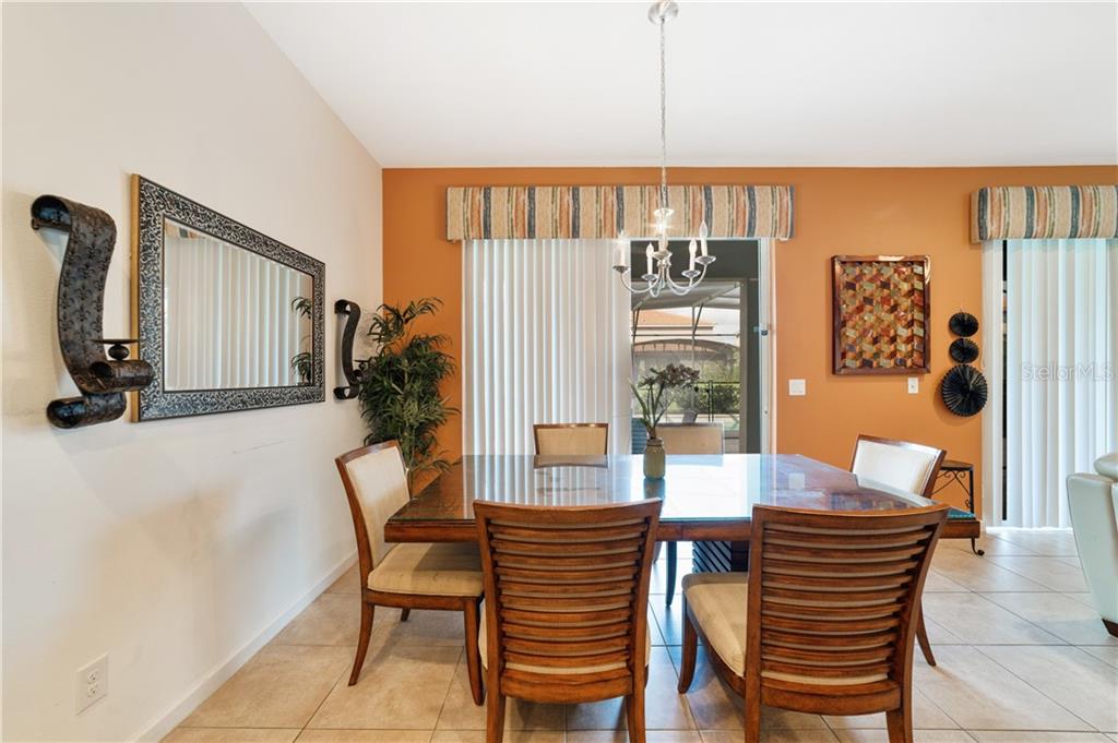 Dining room with glass table and chairs.