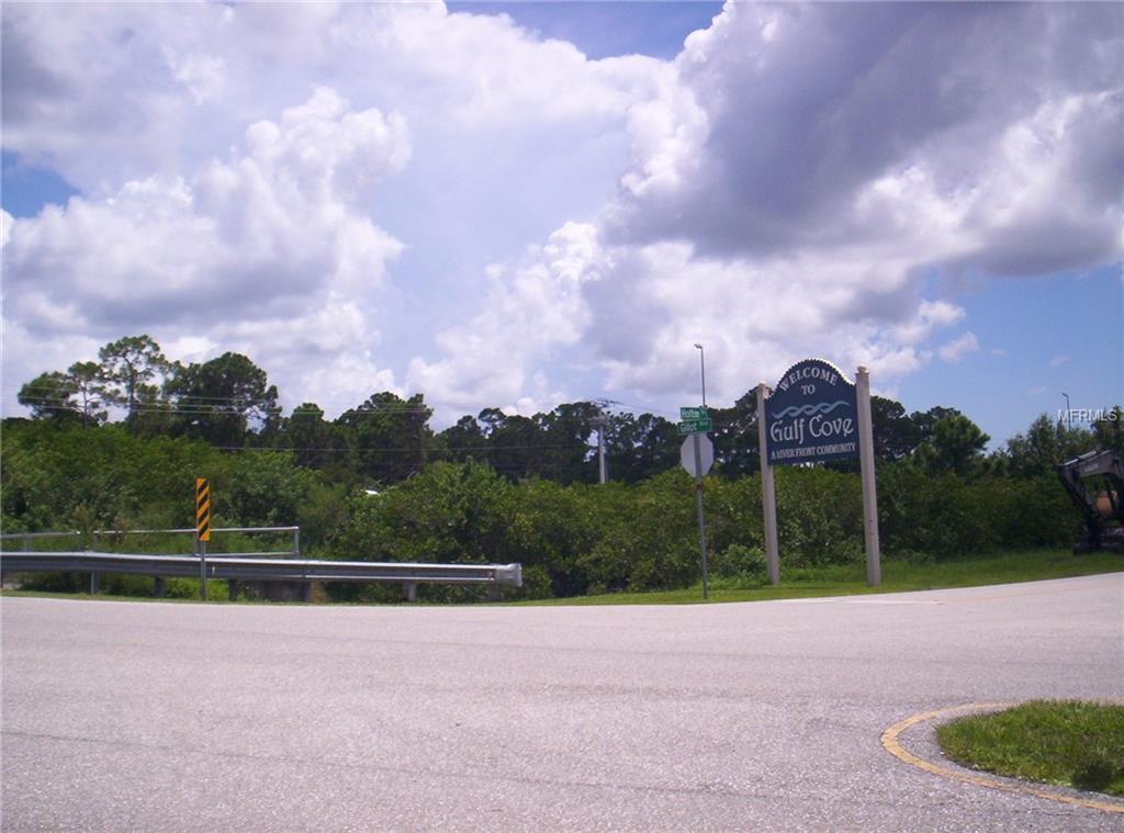 Welcome to Gulf Cove sign with trees and sky.