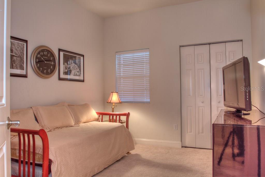 Guest bedroom with a daybed and tv.