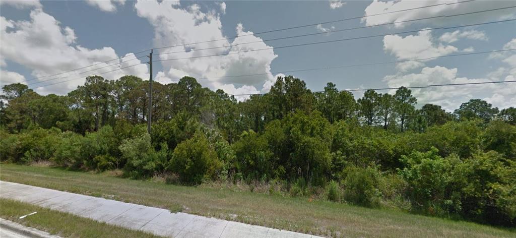 Wooded lot with road and power lines.