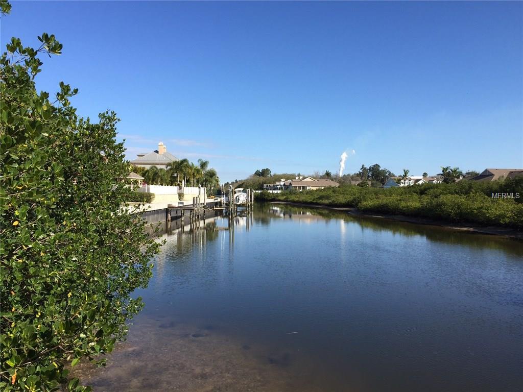 Calm waterway with homes and trees.