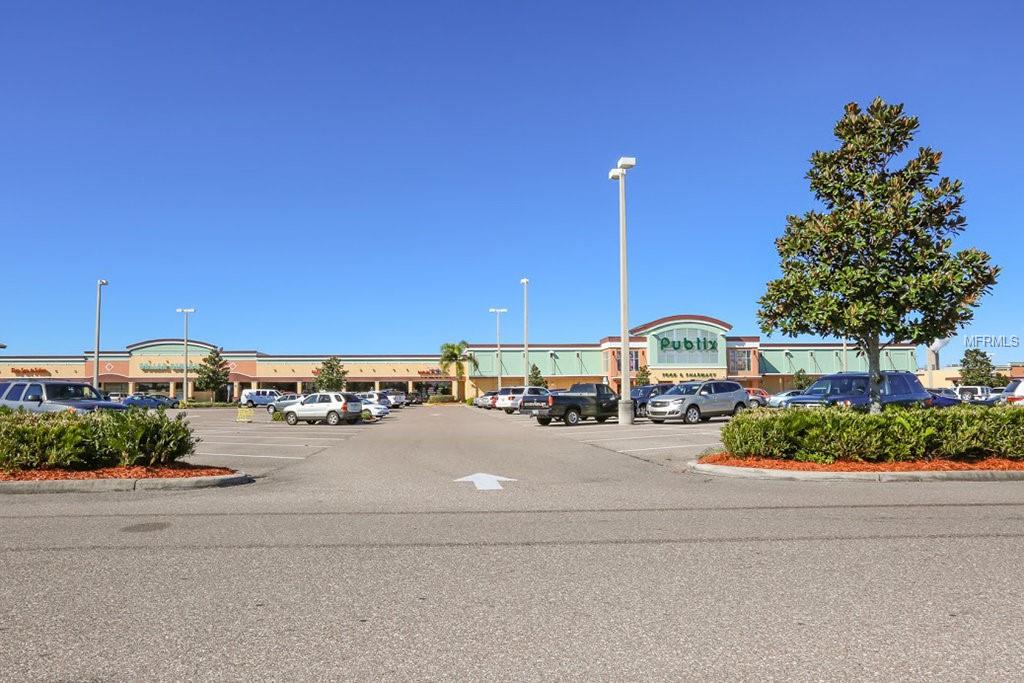 Publix grocery store parking lot with cars.