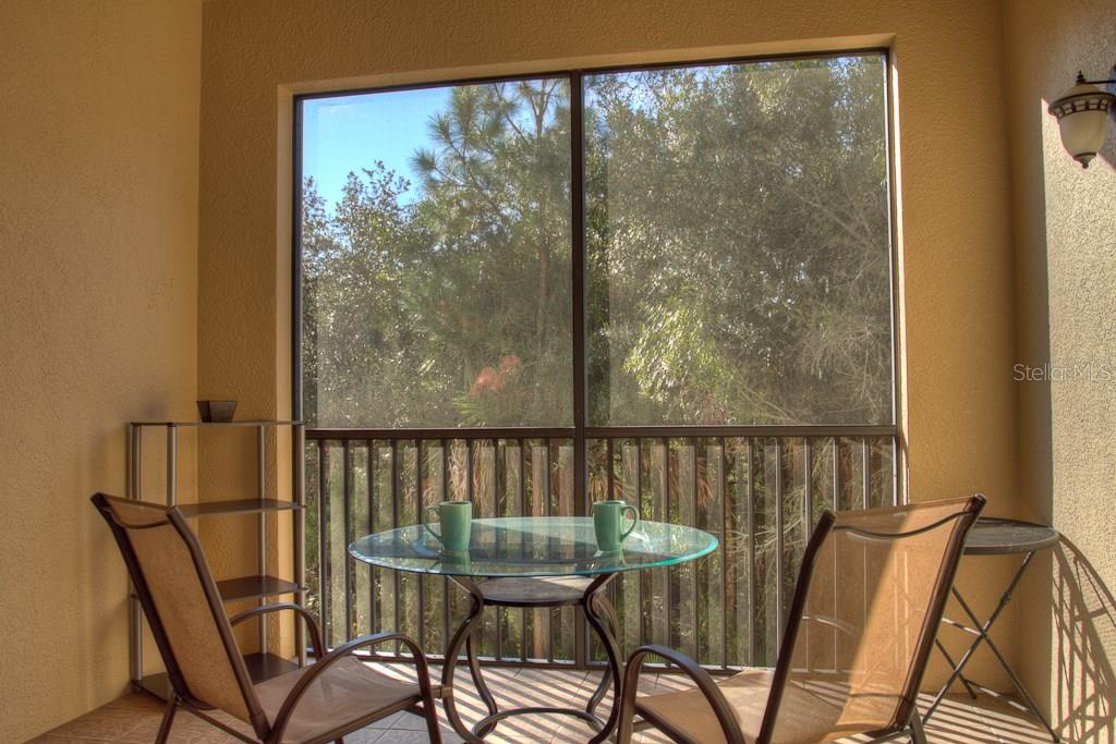 Two chairs and a table on a patio.