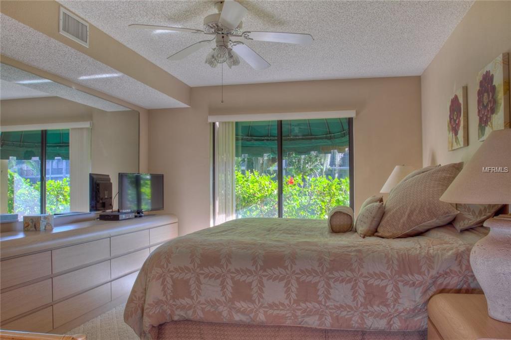 Bedroom with a king bed and a view of nature.