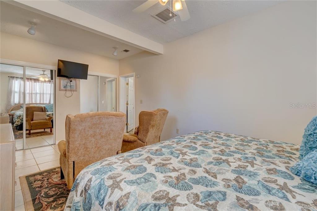 Bedroom with a seashell patterned bed.