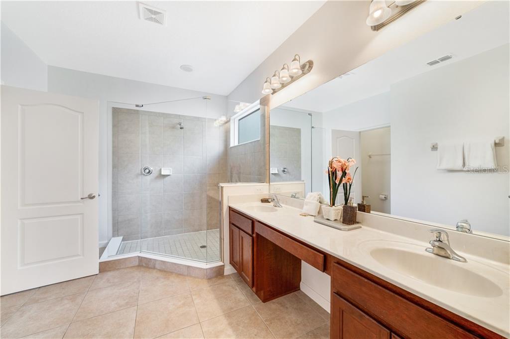 Modern bathroom with double vanity and shower.