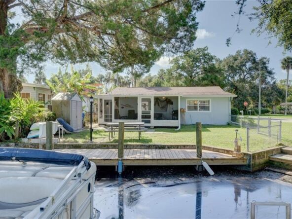 Waterfront home with a dock and boat.