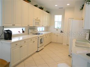 White kitchen with stainless steel appliances.