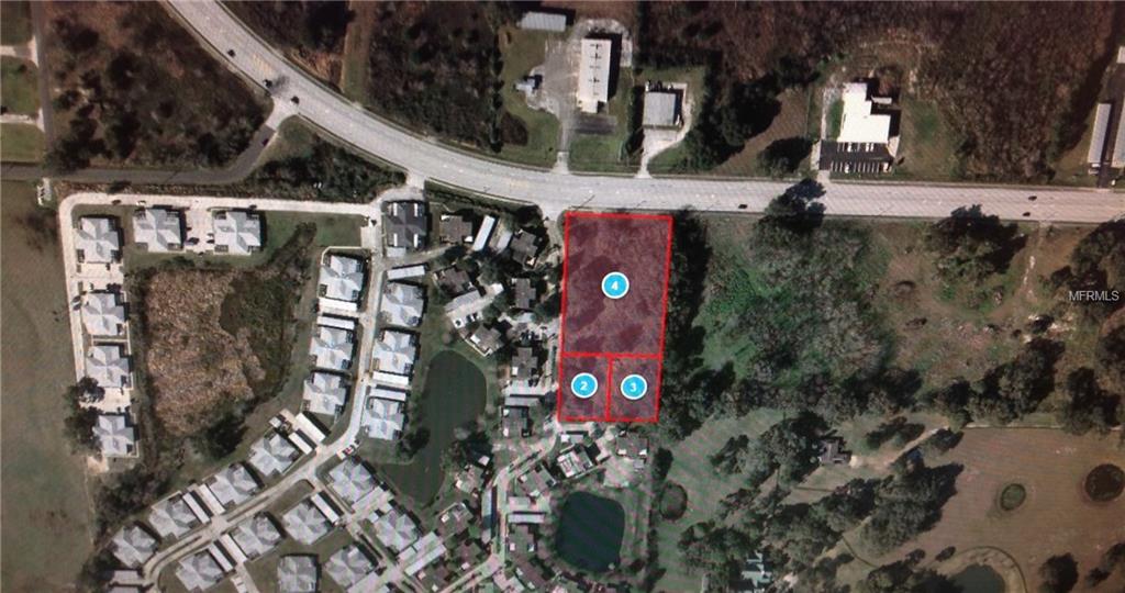 Aerial view of three vacant lots.