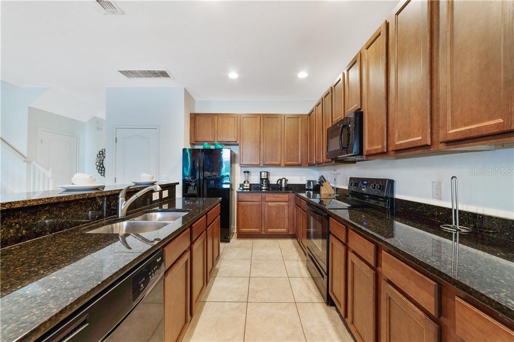 Modern kitchen with black granite countertops.