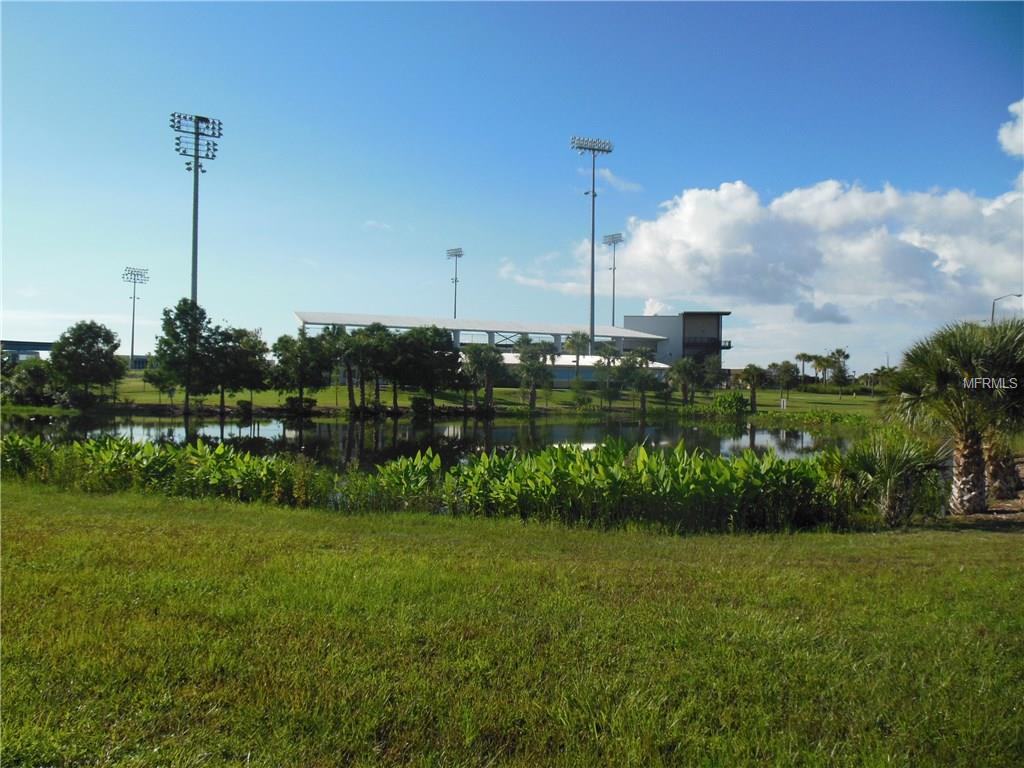 A pond in front of a sports complex.