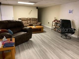 Living room with leather furniture and wood floors.