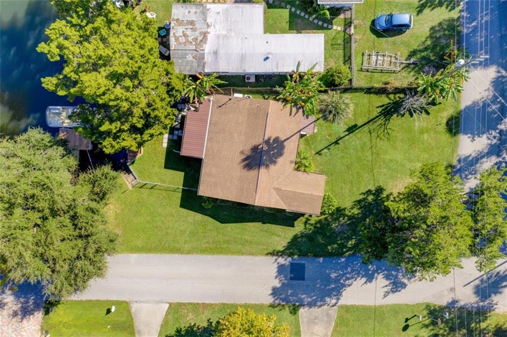 Aerial view of a house with a yard.