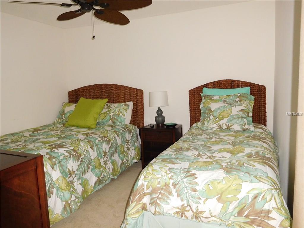 Two twin beds with tropical bedding.