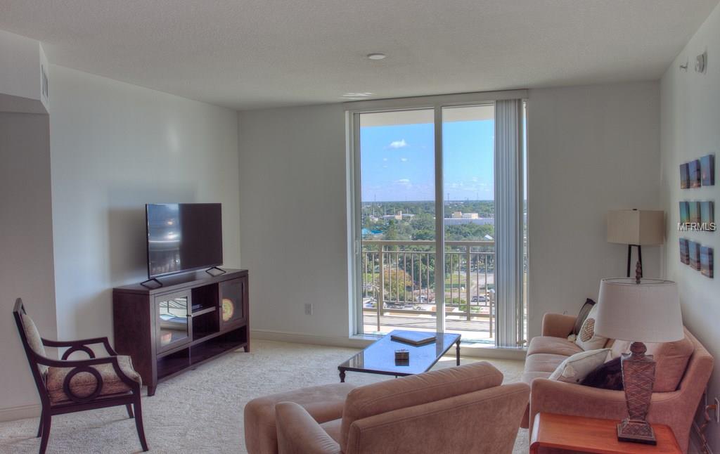 Living room with city view and furniture.