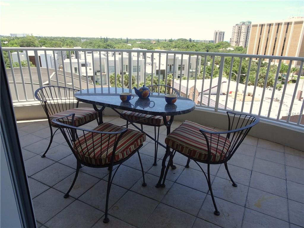 Balcony patio table with four chairs.