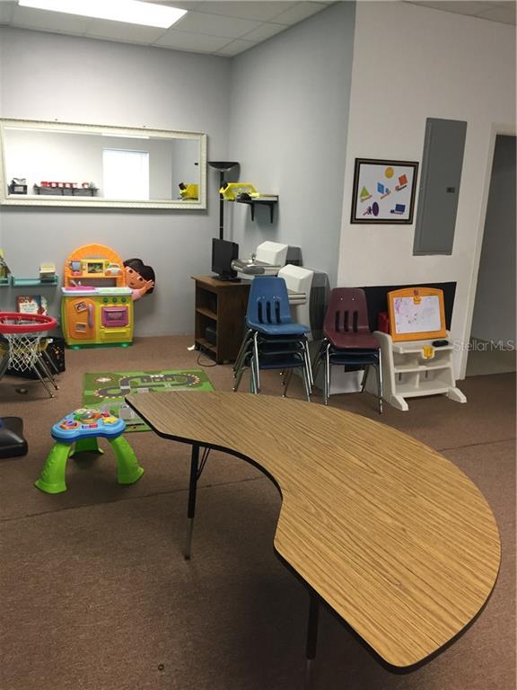 Classroom with table, chairs, and toys.