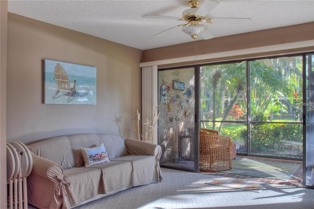 Living room with sofa and sliding door to patio.