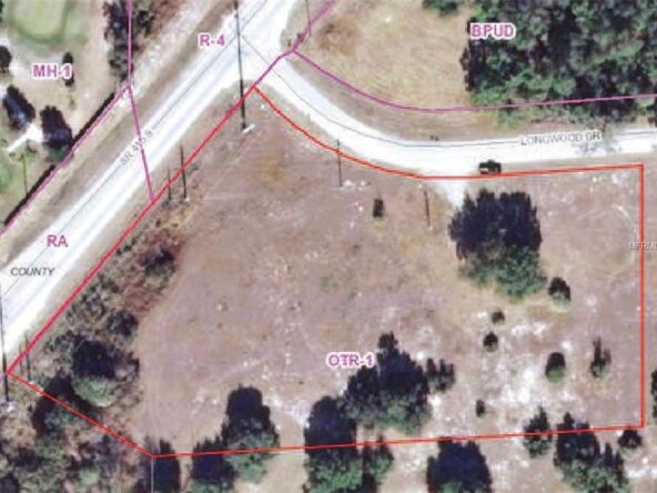 Aerial view of a wooded lot for sale.