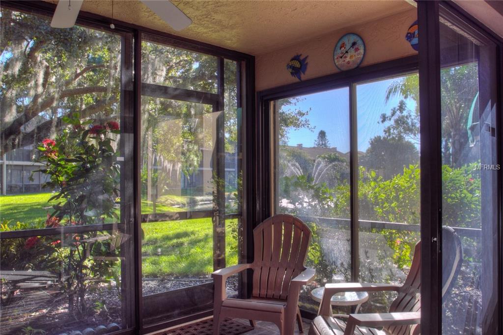 Two chairs facing a view of green trees.