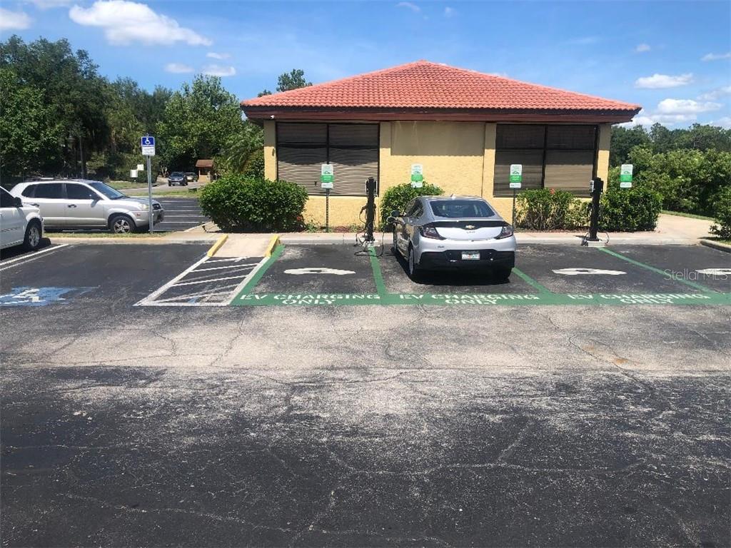 Electric vehicle charging stations with a car.