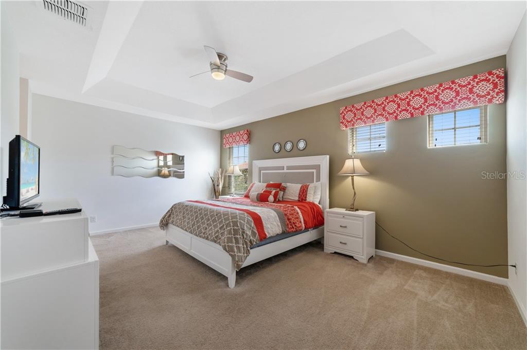 Bedroom with king bed and windows.