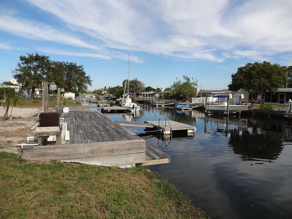 Wooden dock with boats on a canal.