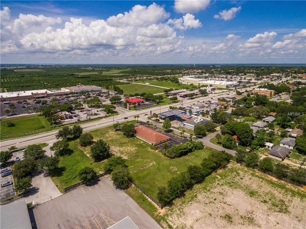 Aerial view of vacant land with businesses.