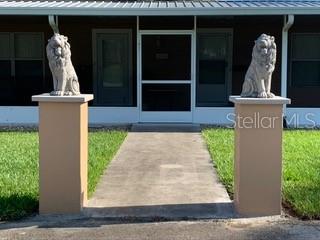 Two lion statues flanking the entrance to a house.