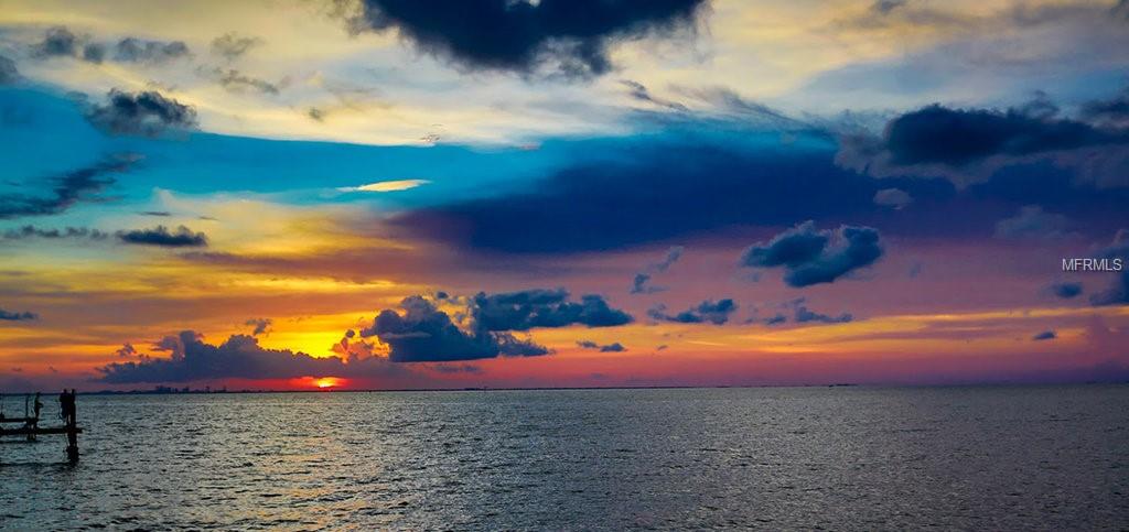 Colorful sunset over calm ocean water.