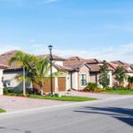 Row of suburban homes with palm trees.