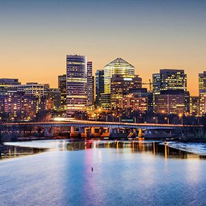 City skyline at dusk with a river.