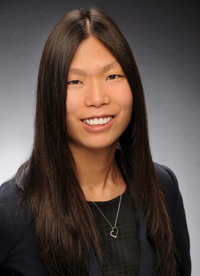 Smiling woman with long dark hair.