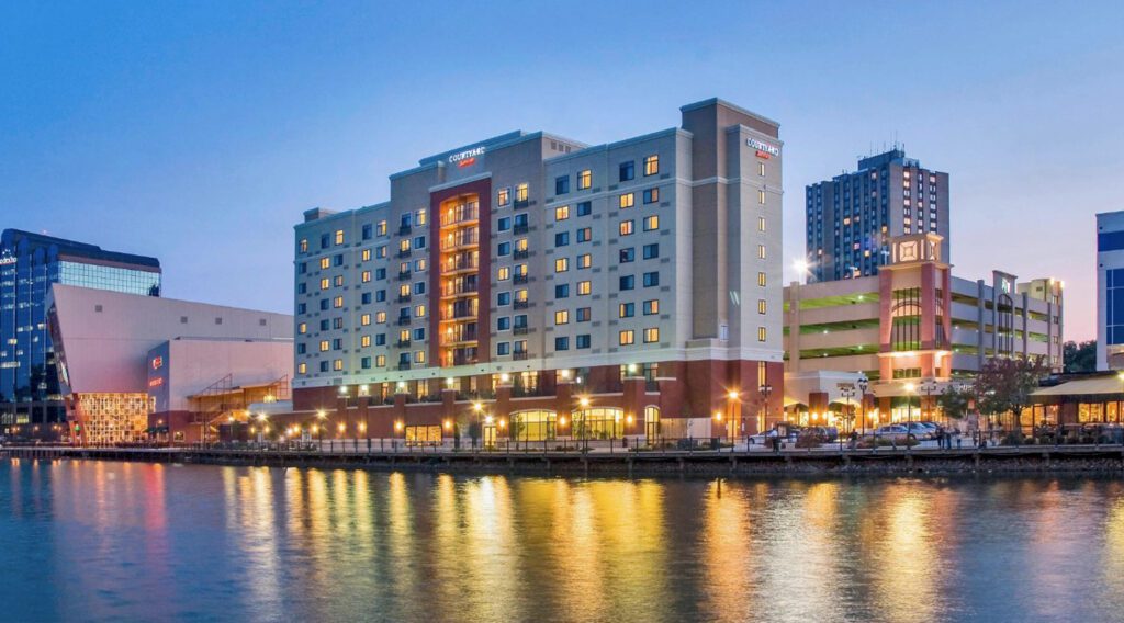 Courtyard Marriott hotel by the water at night.