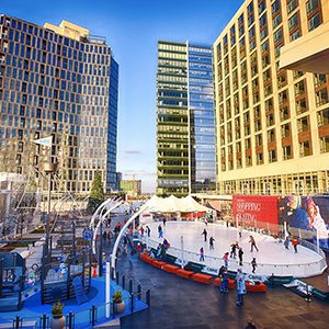 Outdoor ice skating rink in a city square.