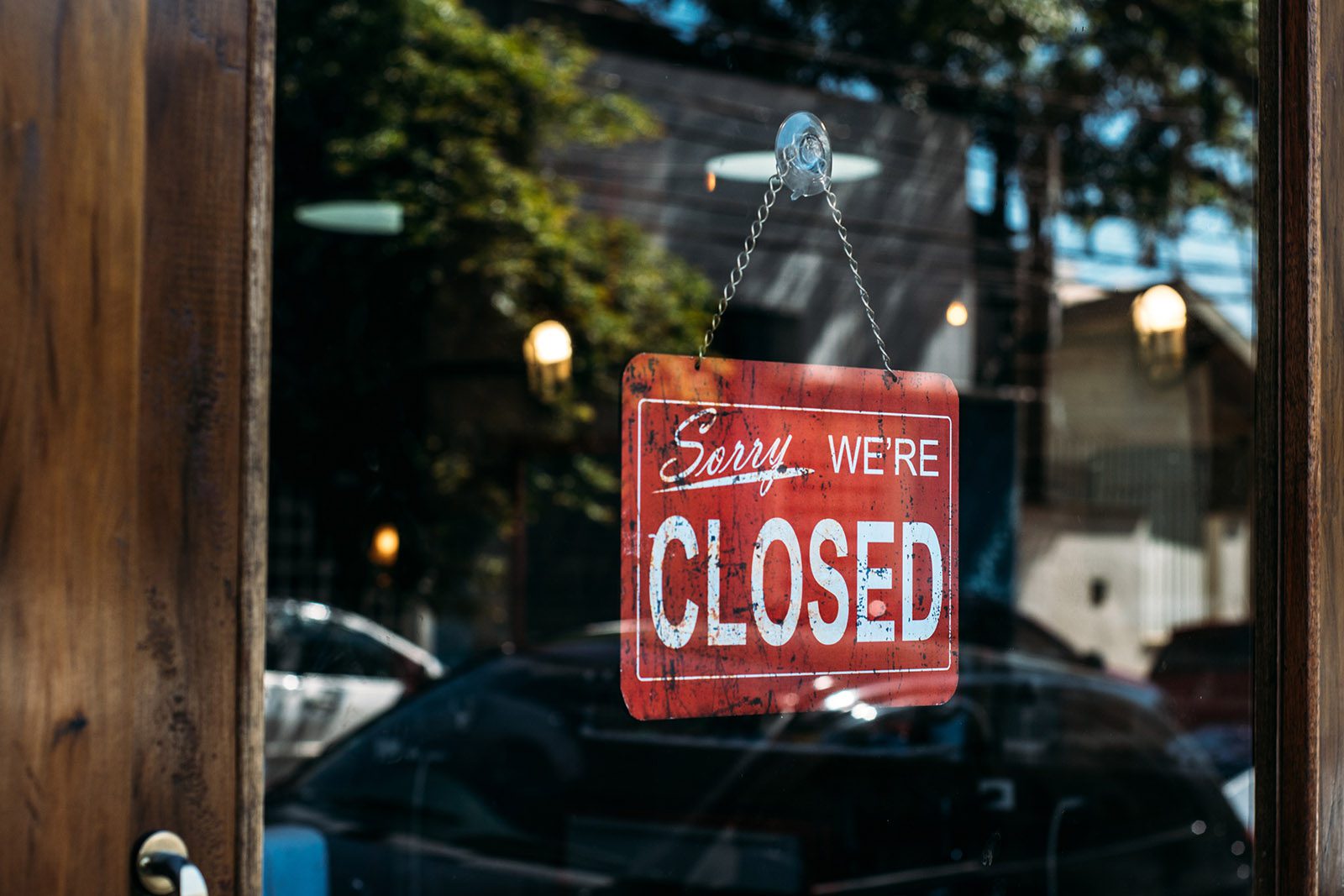 Red "Sorry we're closed" sign on a door.